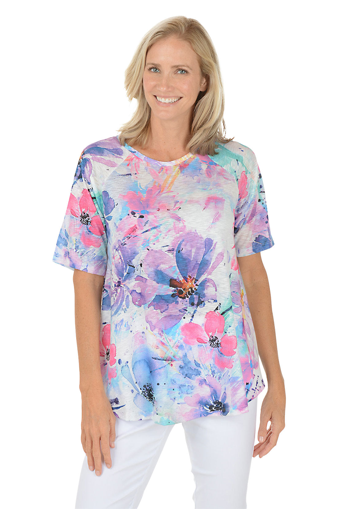 A woman wearing a purple short sleeve shirt with a floral pattern.