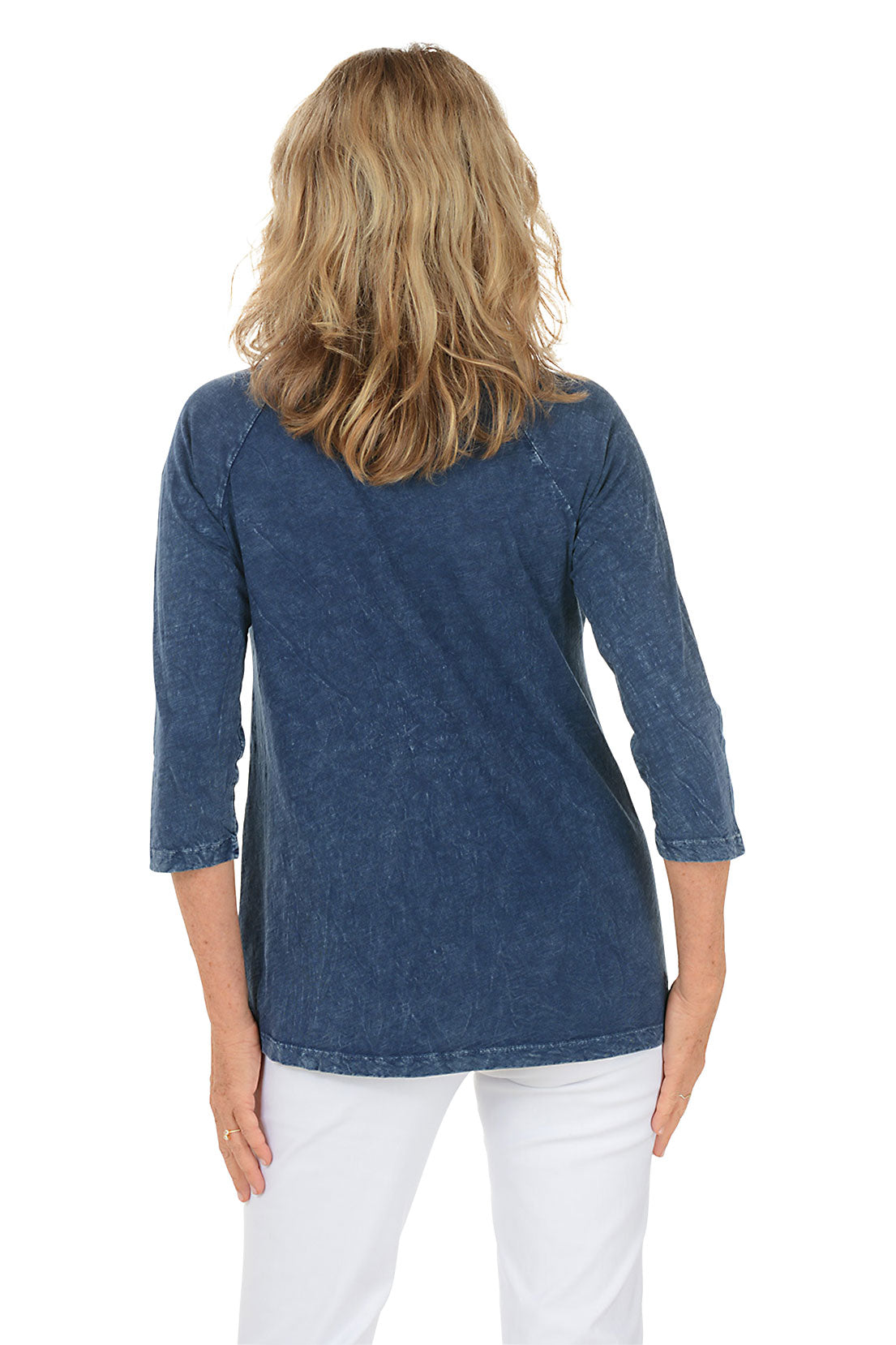 A woman wearing a blue 3/4 sleeve shirt with a daisy pattern. Back shot.