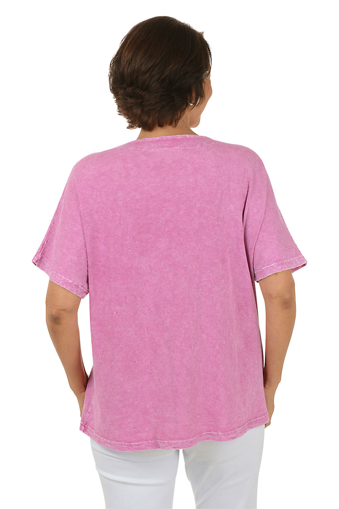 Woman wearing a pink floral-patterned shirt on a white background