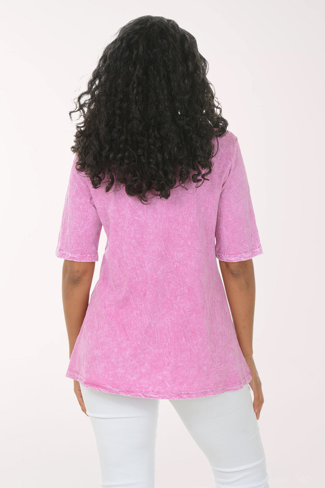 Woman wearing a pink abstract patterned top on a white background