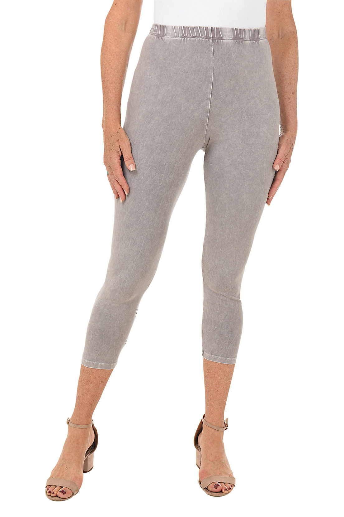 A front shot of a model wearing a pair of slate mineral wash capri leggings with an elastic waistband, made from stretchy cotton fabric.