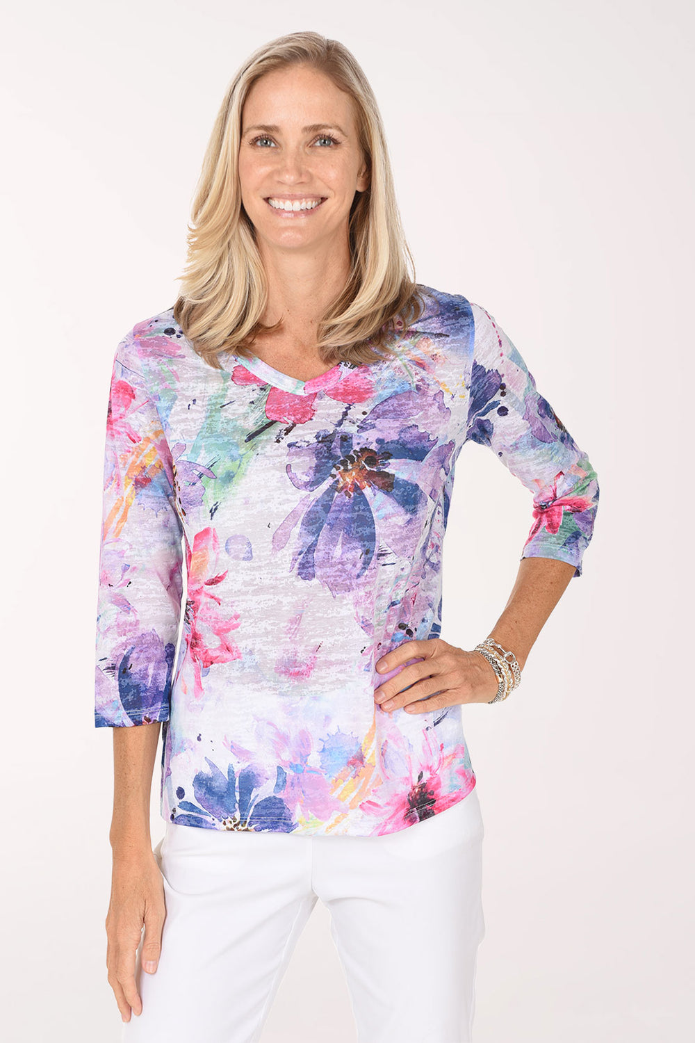 Model wearing the Jess and Jane Lady Burnout V-Neck Knit Top, lavender, violet, pink and blue watercolor blooms on white, front view