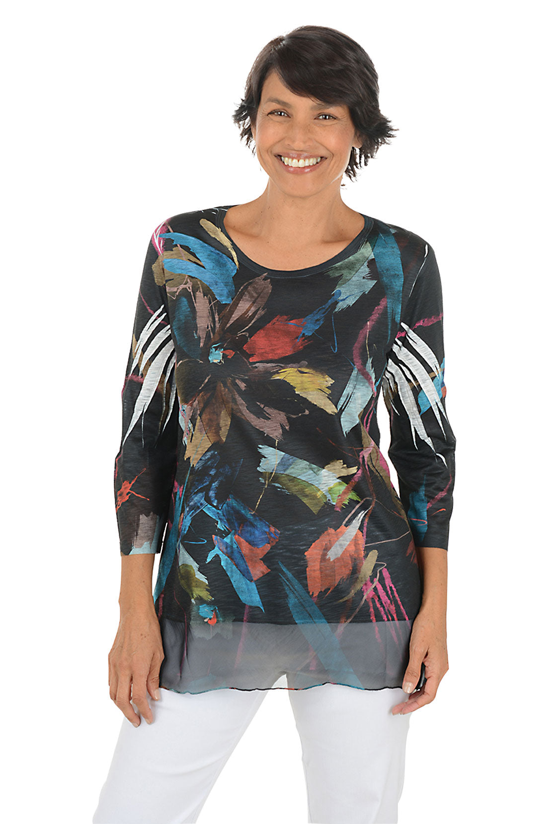 A front shot of a model wearing a colorful floral print top on a white background