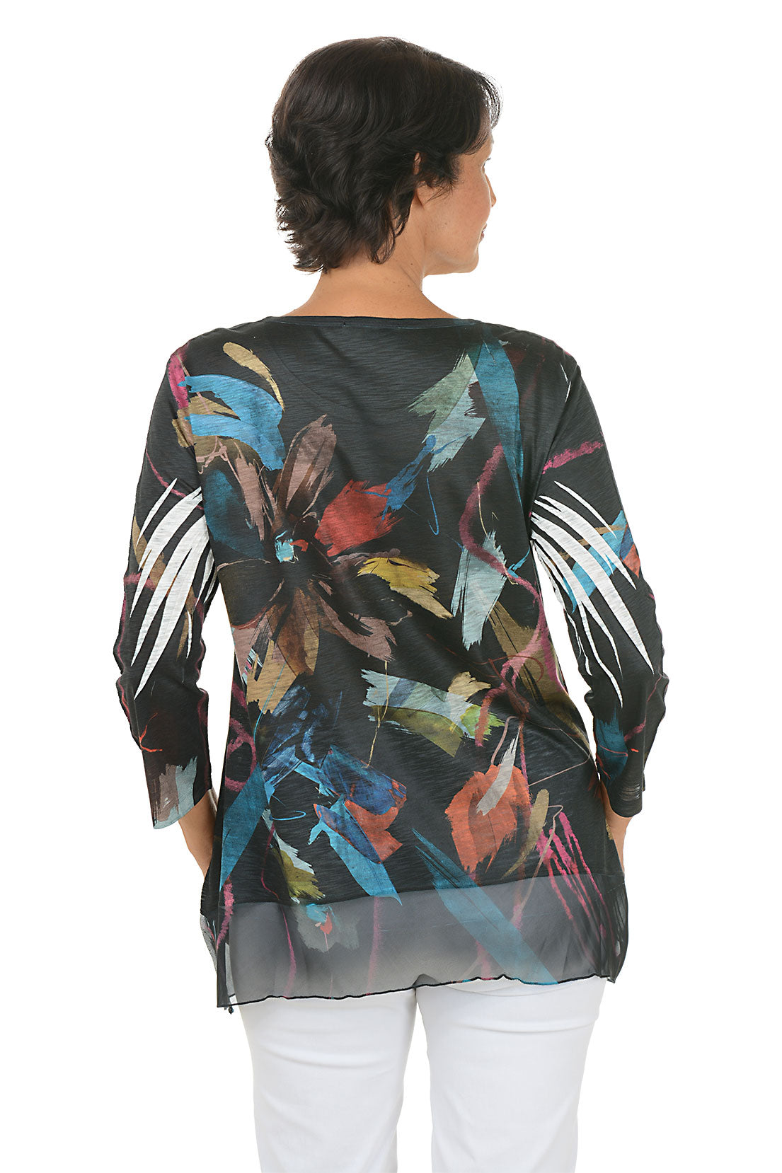 A back shot of a model wearing a colorful floral print top on a white background