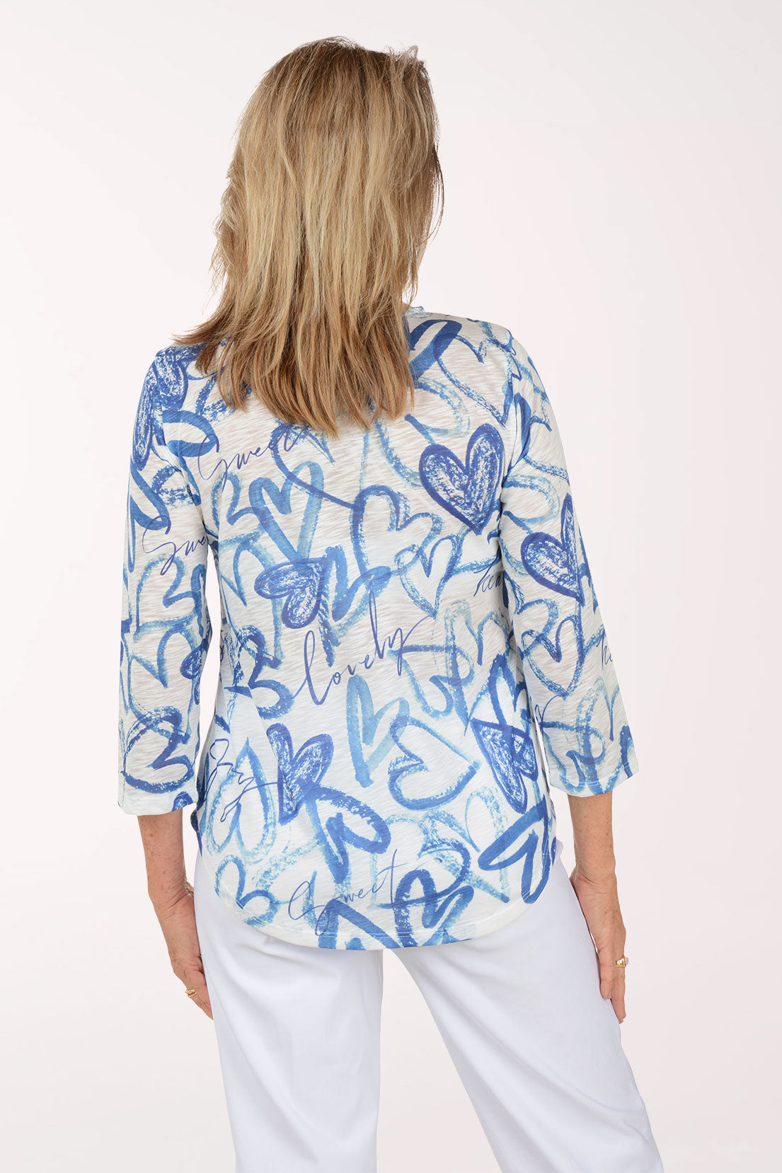 Woman wearing a blue and white patterned top on a white background
