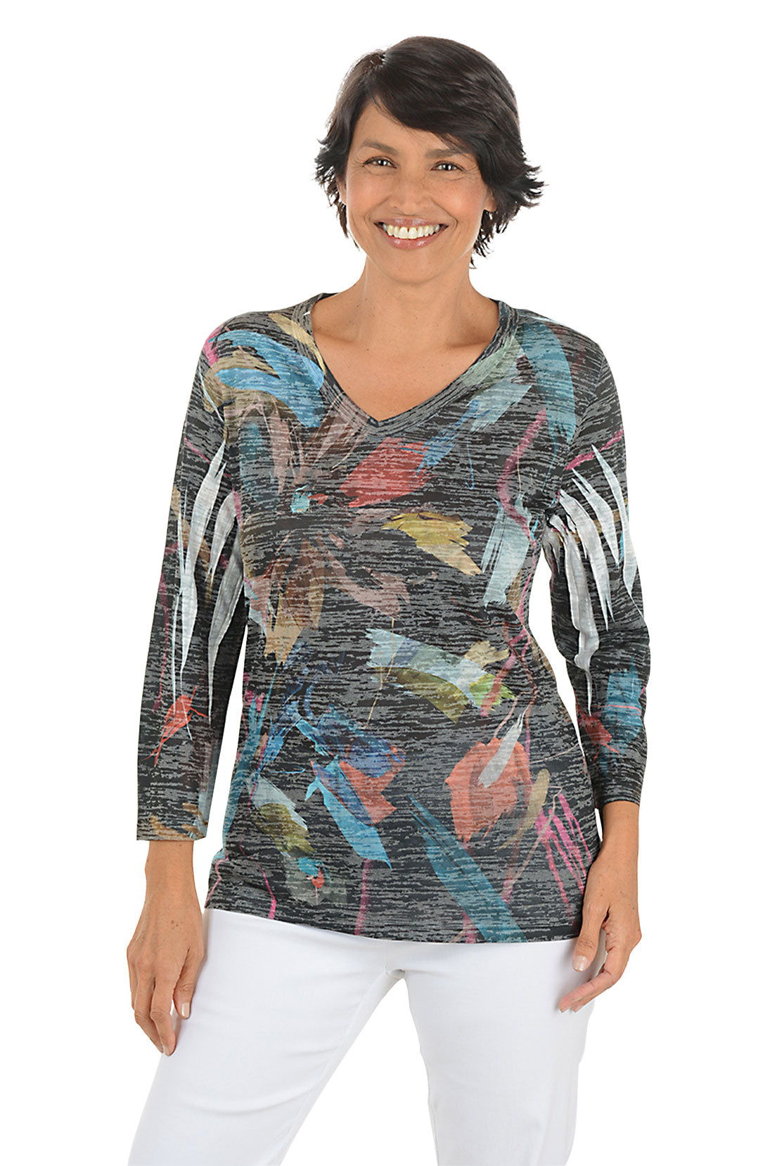 A front shot of a model wearing a colorful long-sleeve top with abstract pattern on a white background