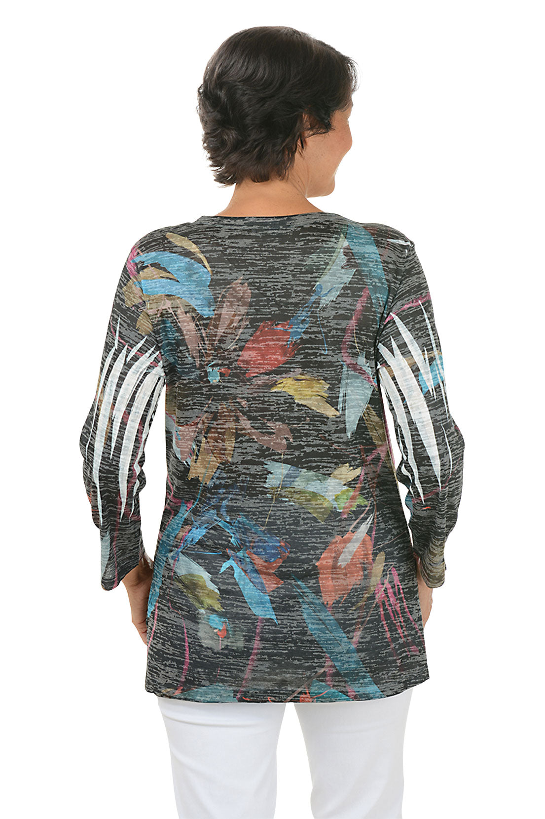 A back shot of a model wearing a colorful long-sleeve top with abstract pattern on a white background