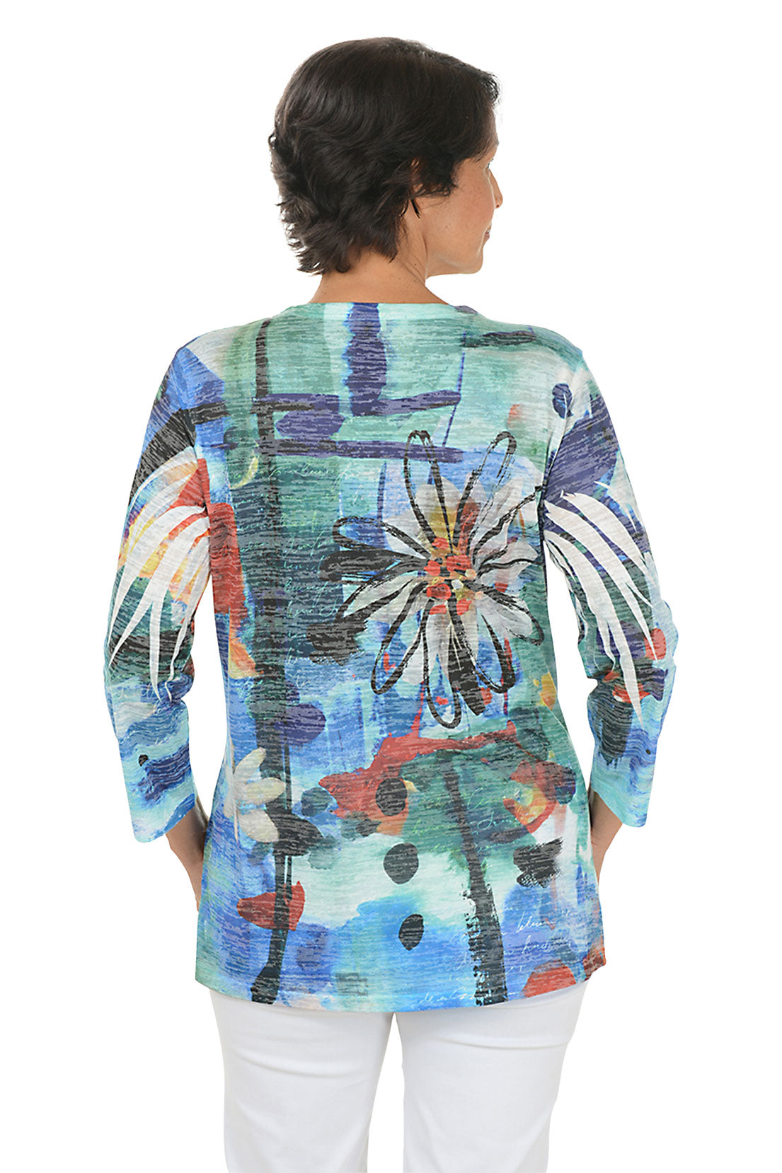 A back shot of a model wearing a colorful floral-patterned top on a white background