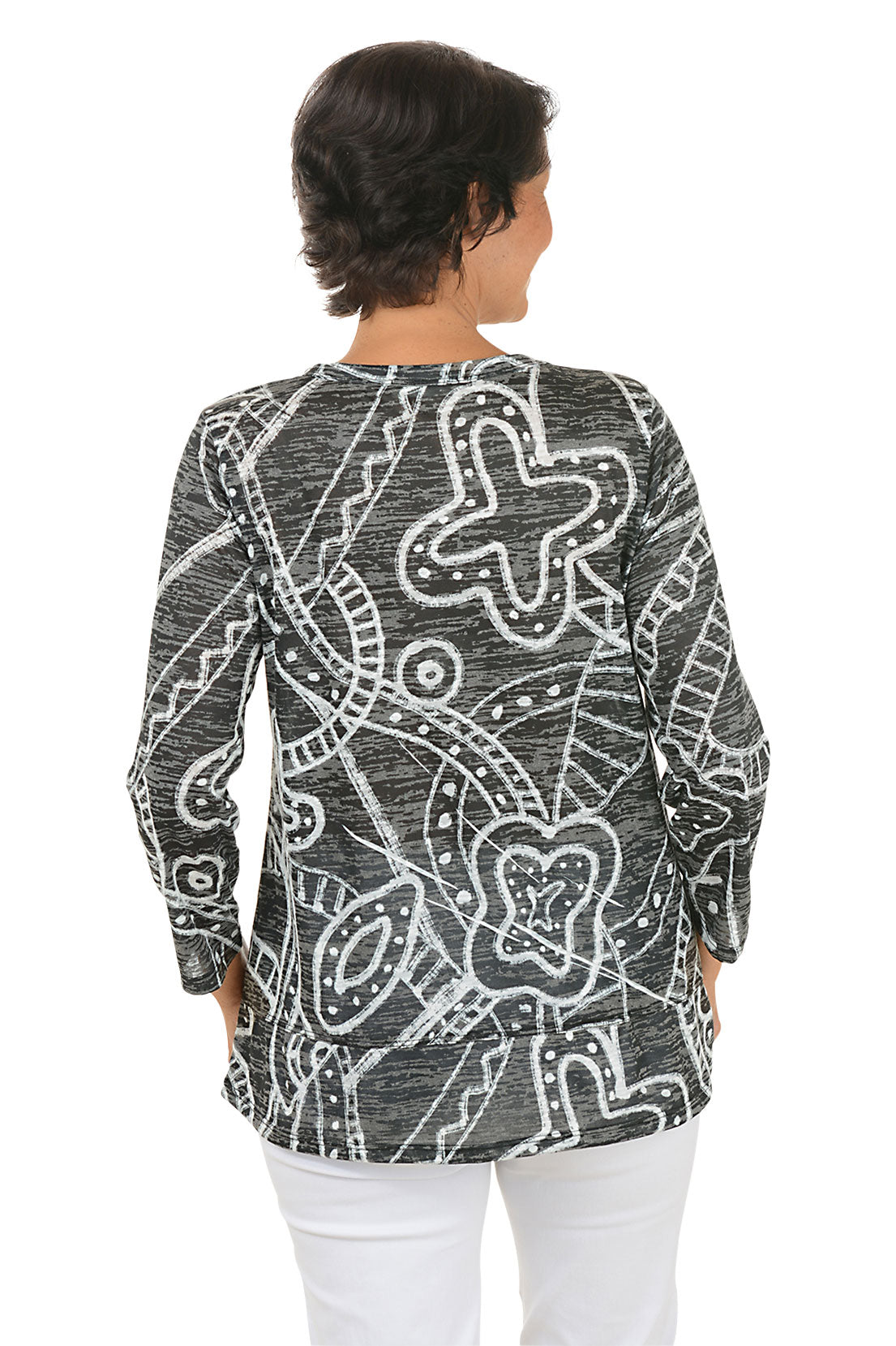 A back shot of a model wearing a black and white patterned top on a white background
