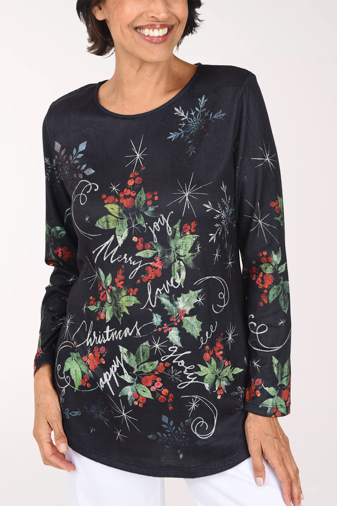 Close front view of the black holly print top, showing the red berries, green leaves and swirling white script across the chest