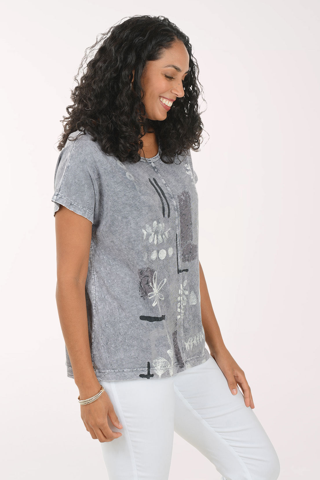 Woman wearing a patterned gray shirt on a white background