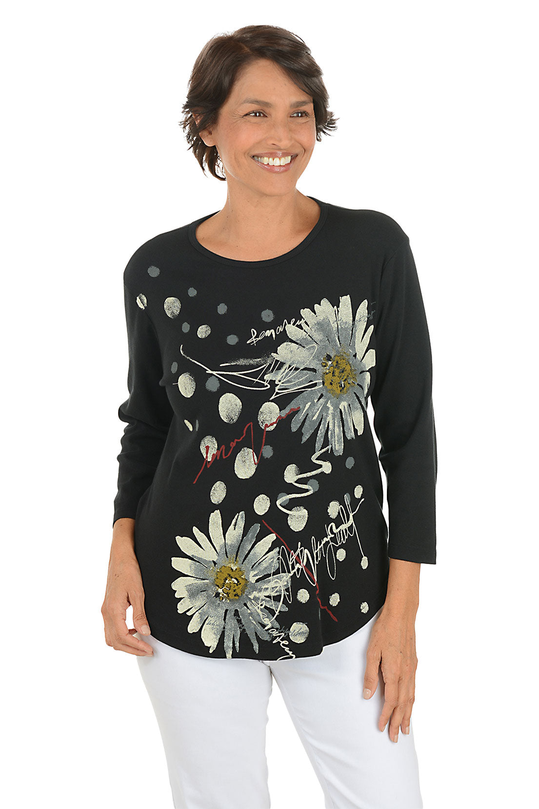 A front shot of a model wearing a black long-sleeve top with floral designs on a white background