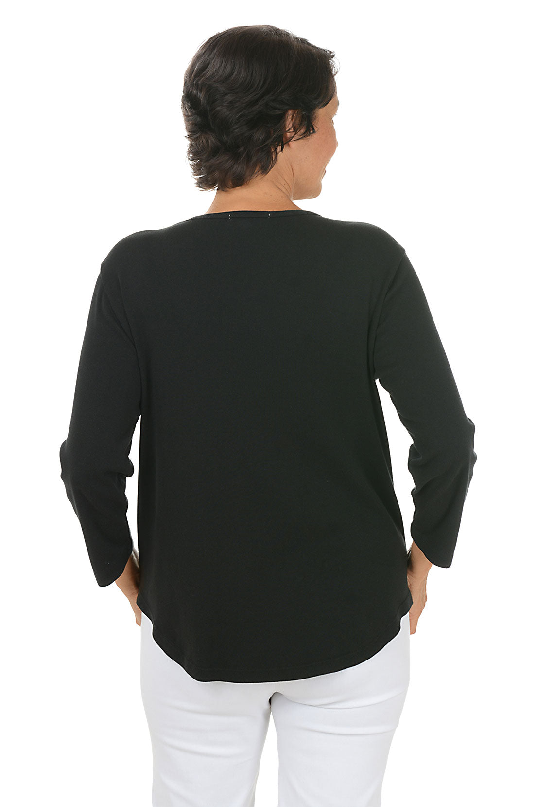 A back shot of a model wearing a black long-sleeve top with floral designs on a white background