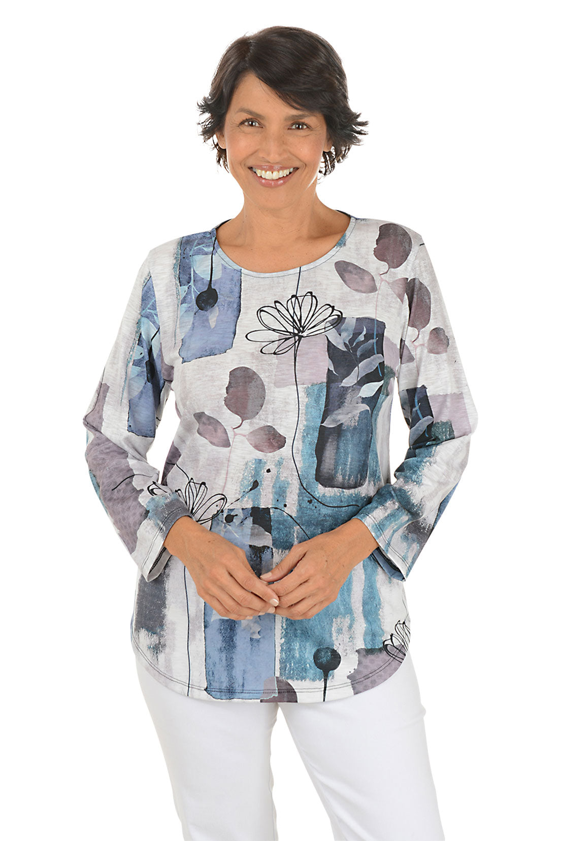 A front shot of a model wearing a colorful abstract patterned top on a white background
