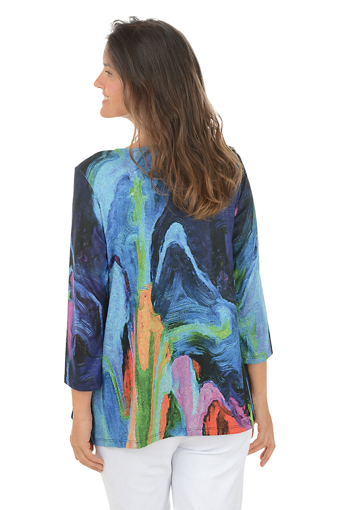 Woman wearing a colorful long-sleeve top with abstract design on a white background. Back shot.
