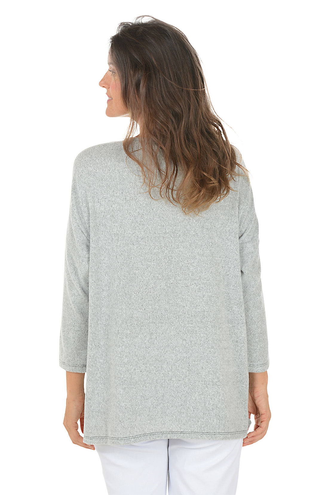 Woman wearing a gray sweater with a floral design on a white background. Back shot.