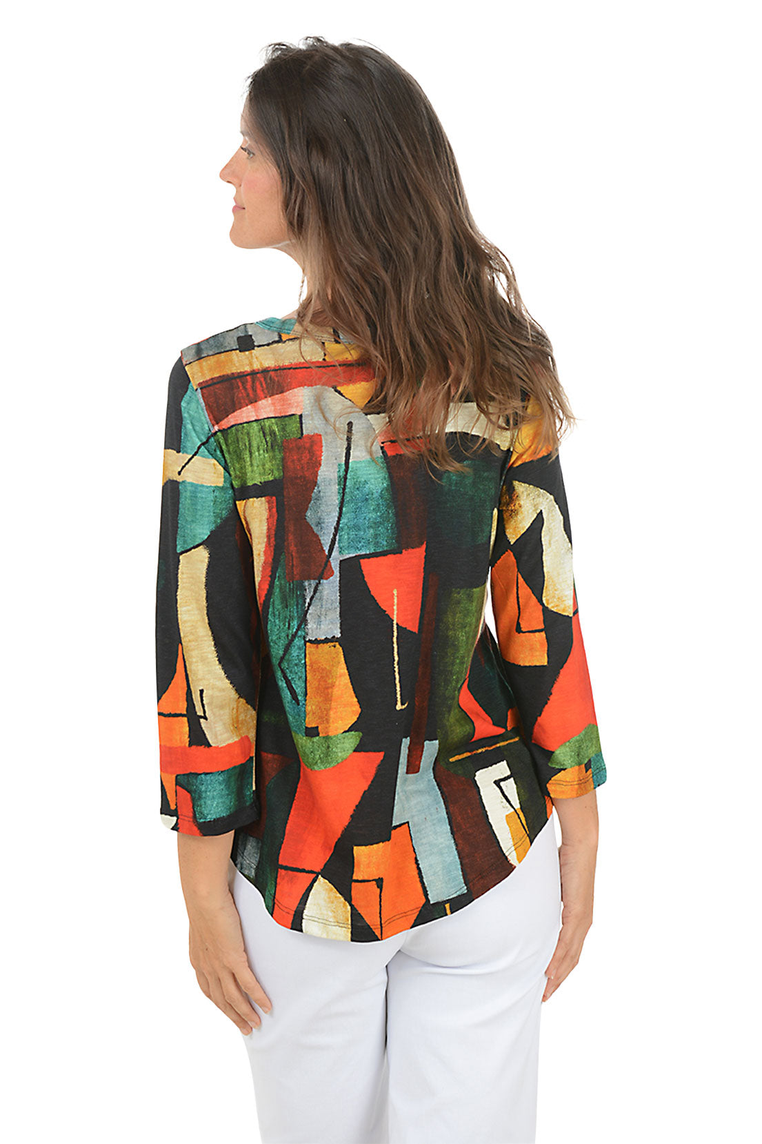 Woman wearing a colorful abstract patterned top on a white background. Back shot.