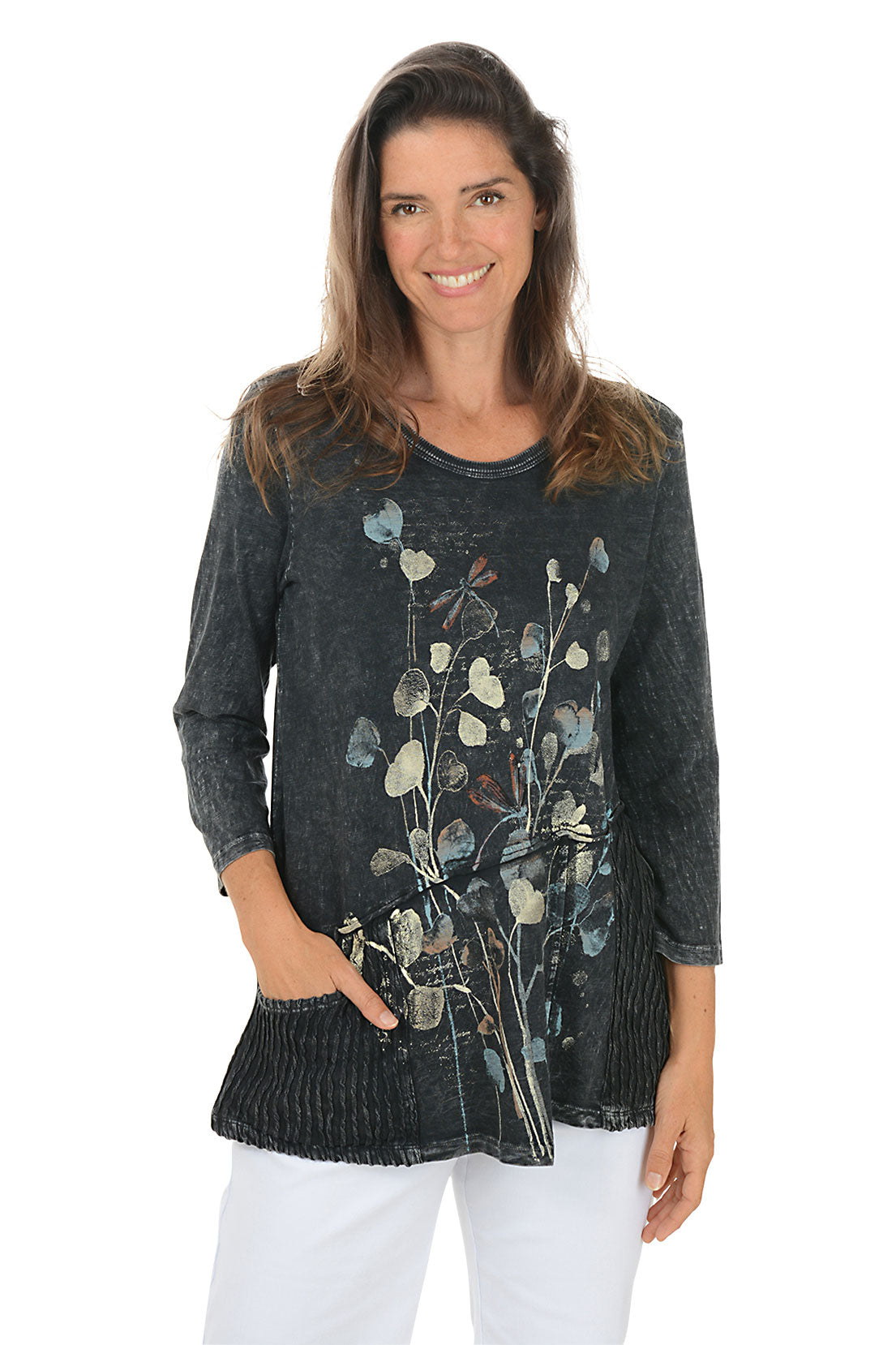 Woman wearing a dark denim shirt with floral embroidery on a white background.