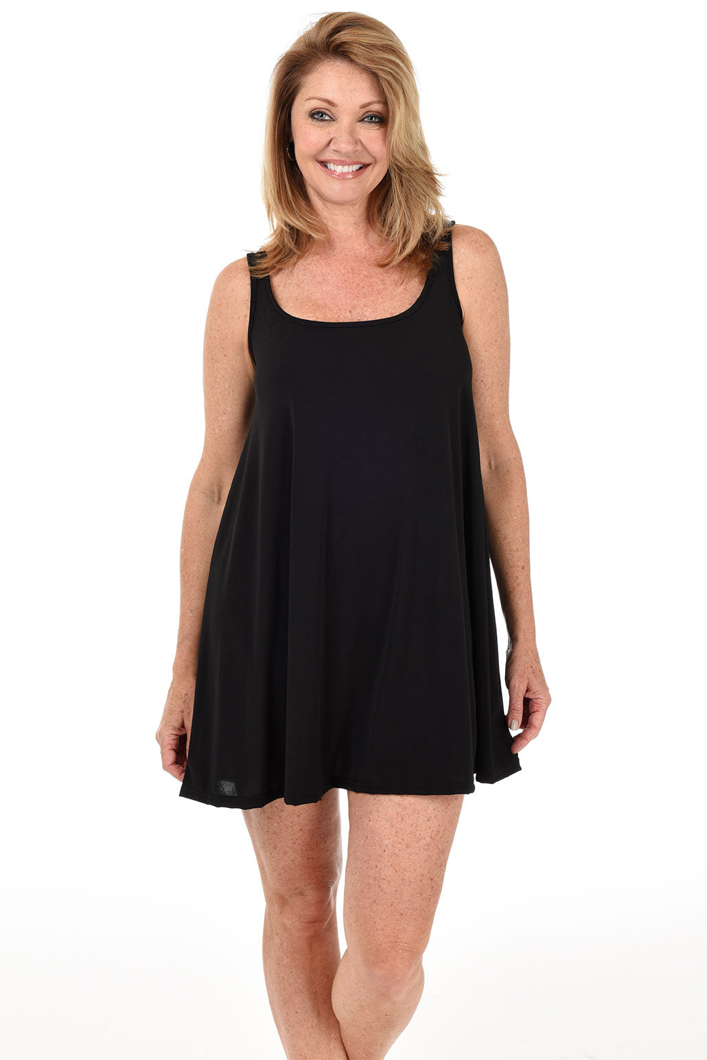 A front shot of a model wearing a black sleeveless swing silhouette dress with a scoop neckline.