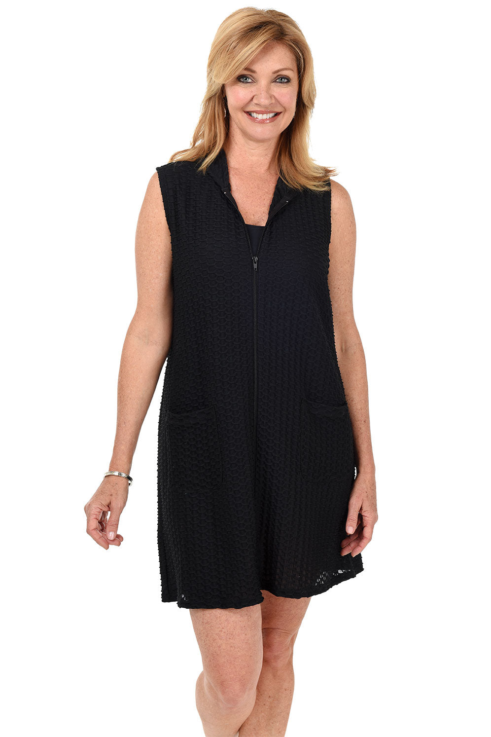 A front shot of a model wearing a black sleeveless cover-up with a hood, full-zip closure, and double front patch pockets.