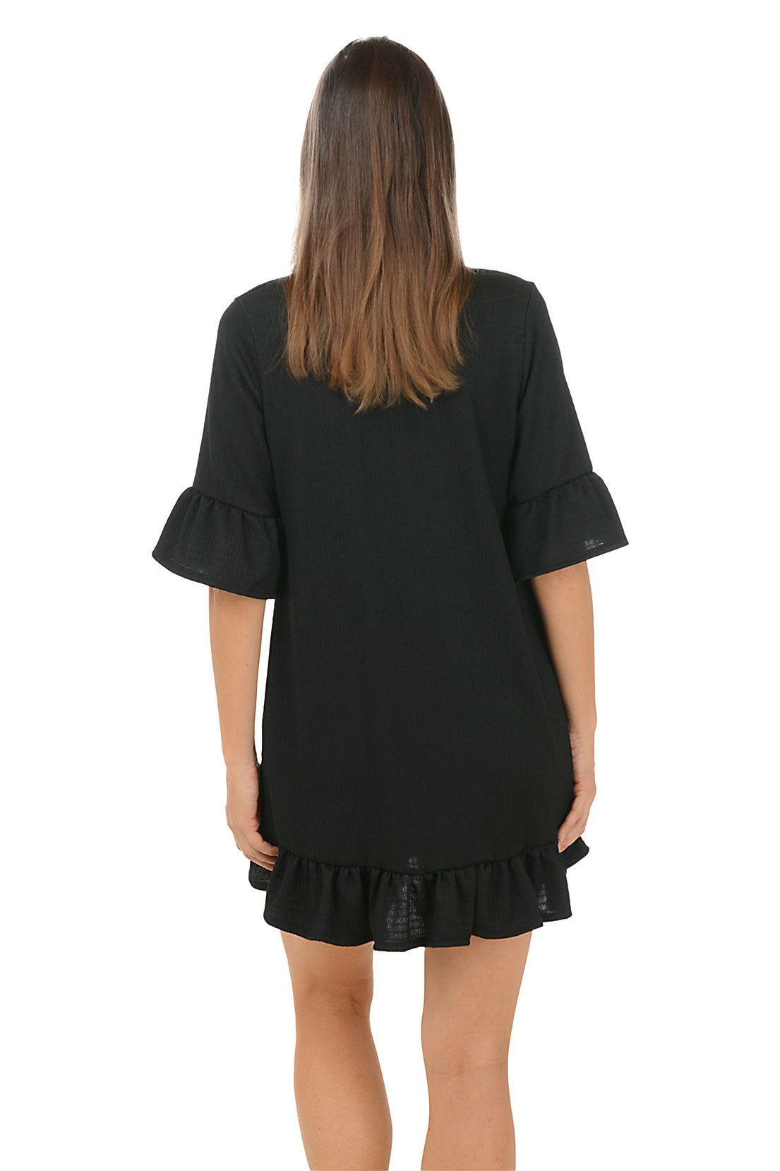Woman wearing a black dress with ruffled sleeves and hem on a white background. Back shot.