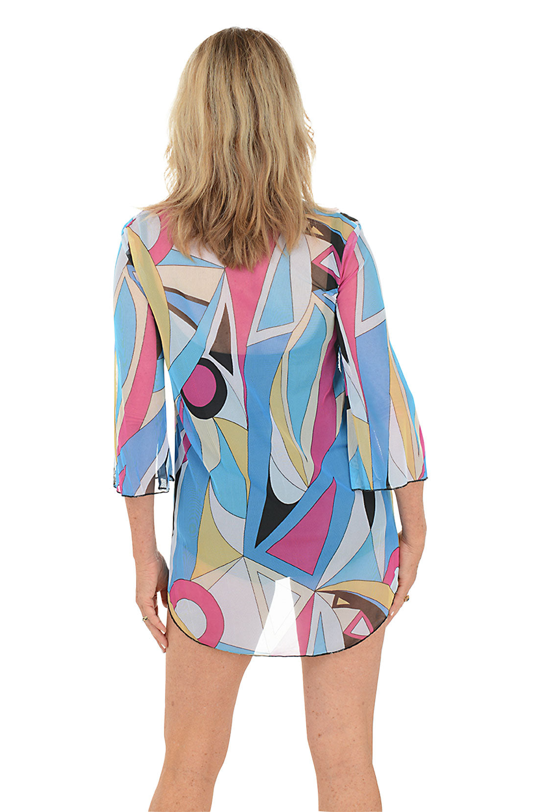 A back shot of a model wearing a multicolored geometric patterned mesh tunic cover-up with a V-neckline and 3/4-length bell sleeves.