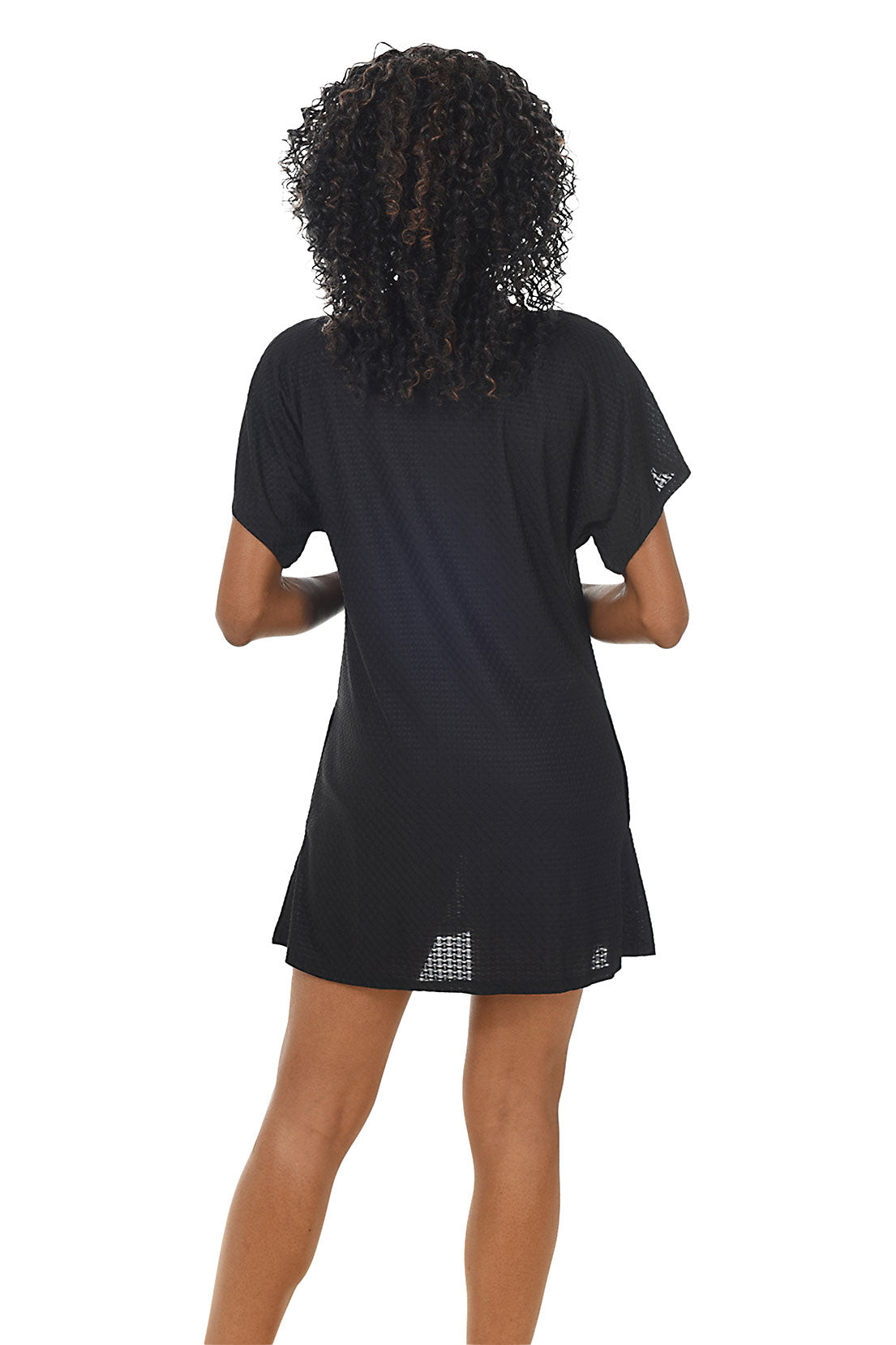 A back shot of a model wearing a black waffle-knit button-front swim cover-up with short dolman sleeves and a V-neckline.