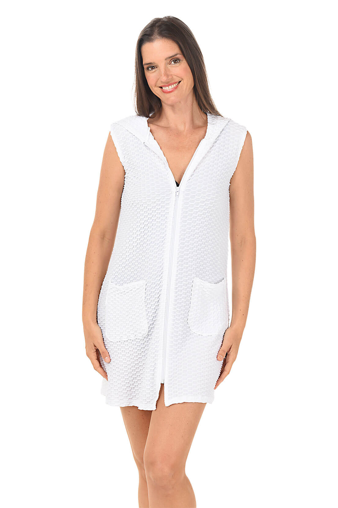 Woman wearing a white sleeveless dress with a pattern on a white background.