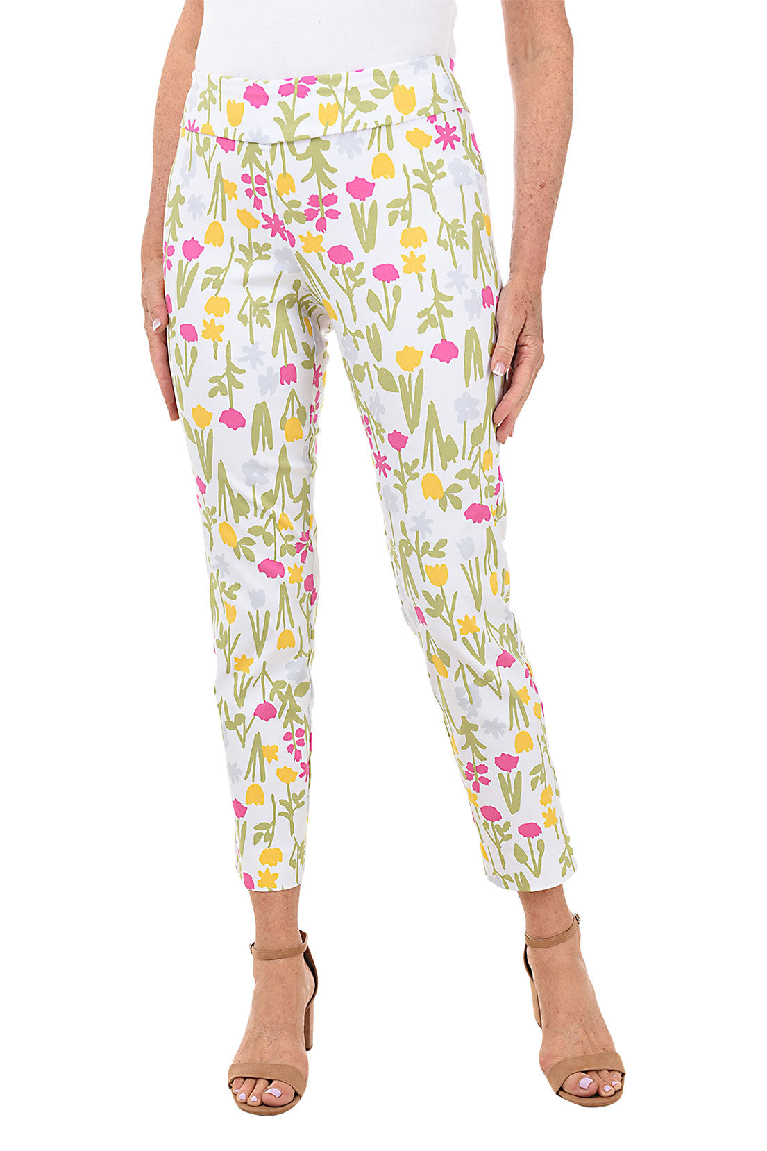 A front shot of a model wearing a pair of pull-on ankle pants with a floral pattern, elasticized waistband, and tummy control liner.