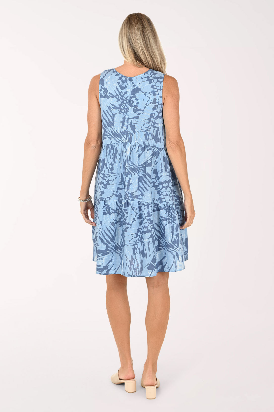 Woman wearing a blue sleeveless dress