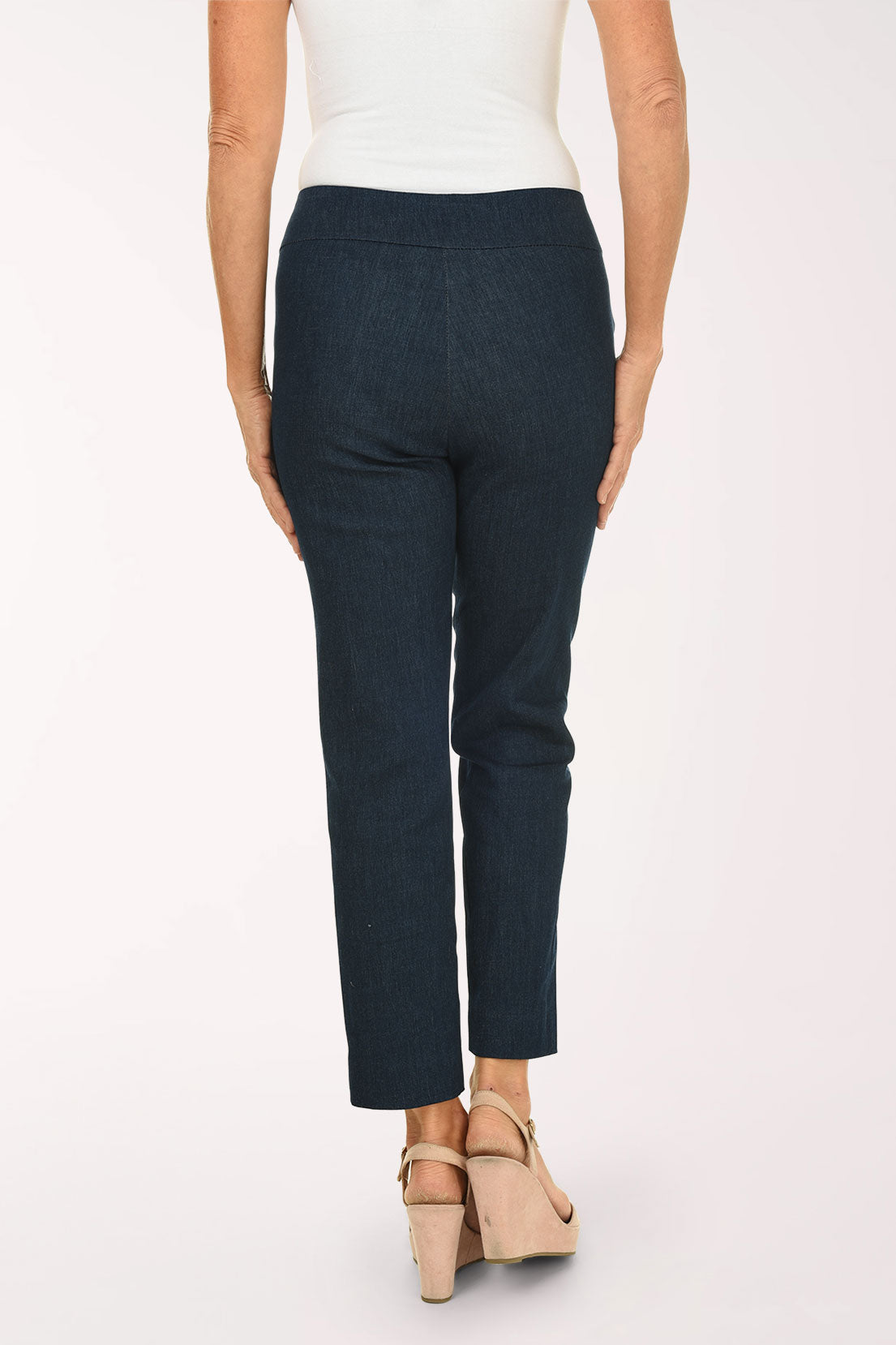 Person wearing navy pants on a white background
