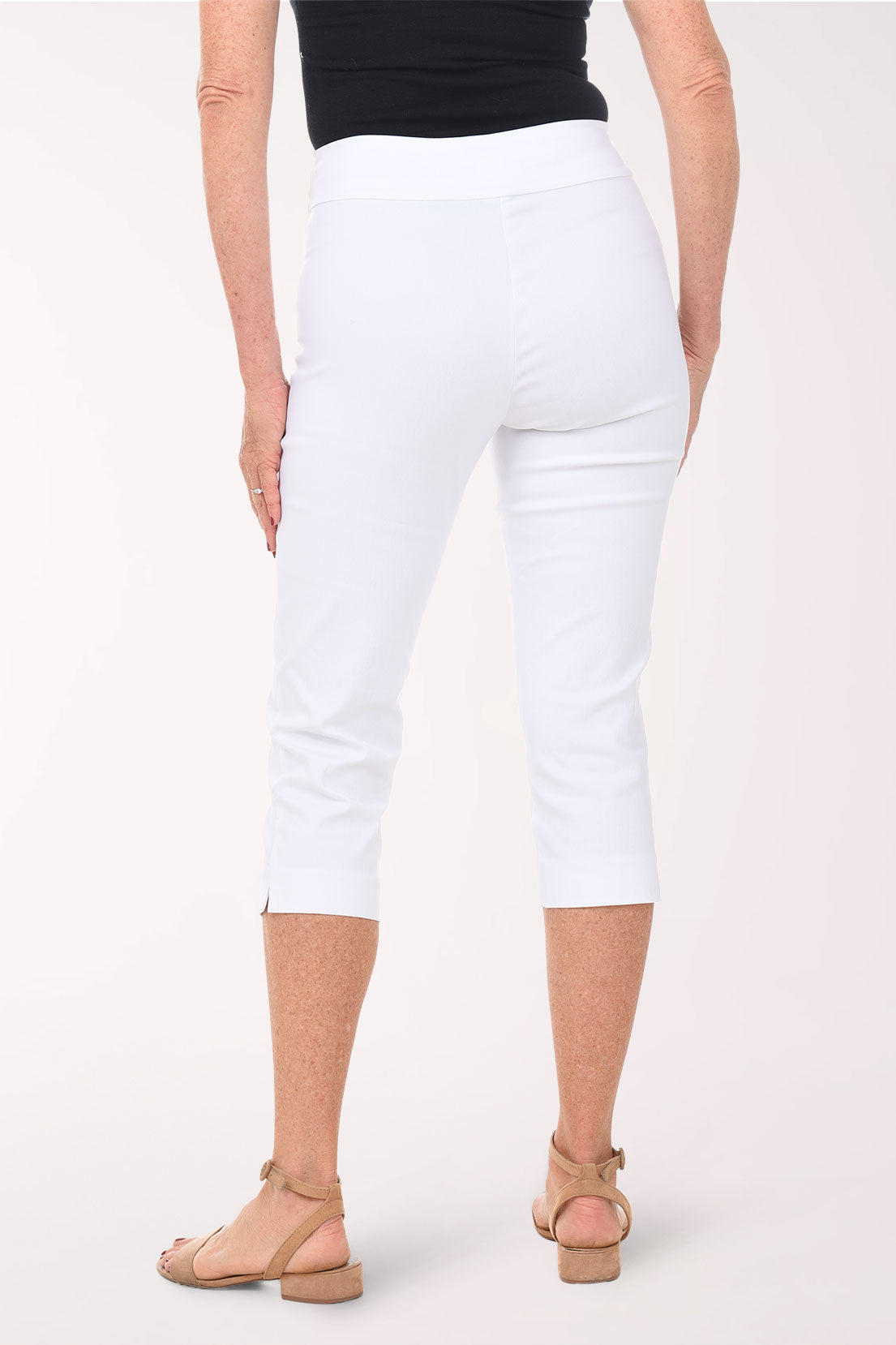 Person wearing white pants on a plain background