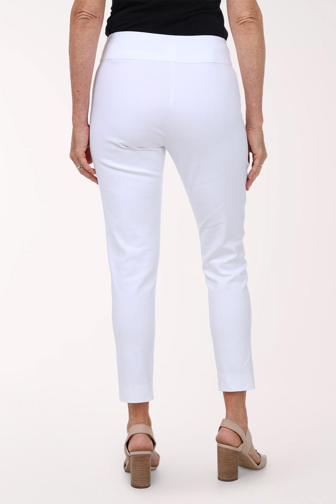 Person wearing white pants on a plain background