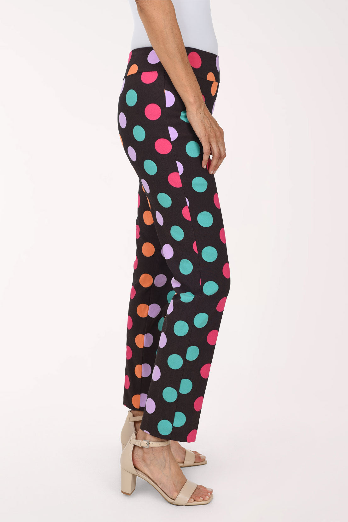 Women wearing black pull-on ankle pants with multicolored dots