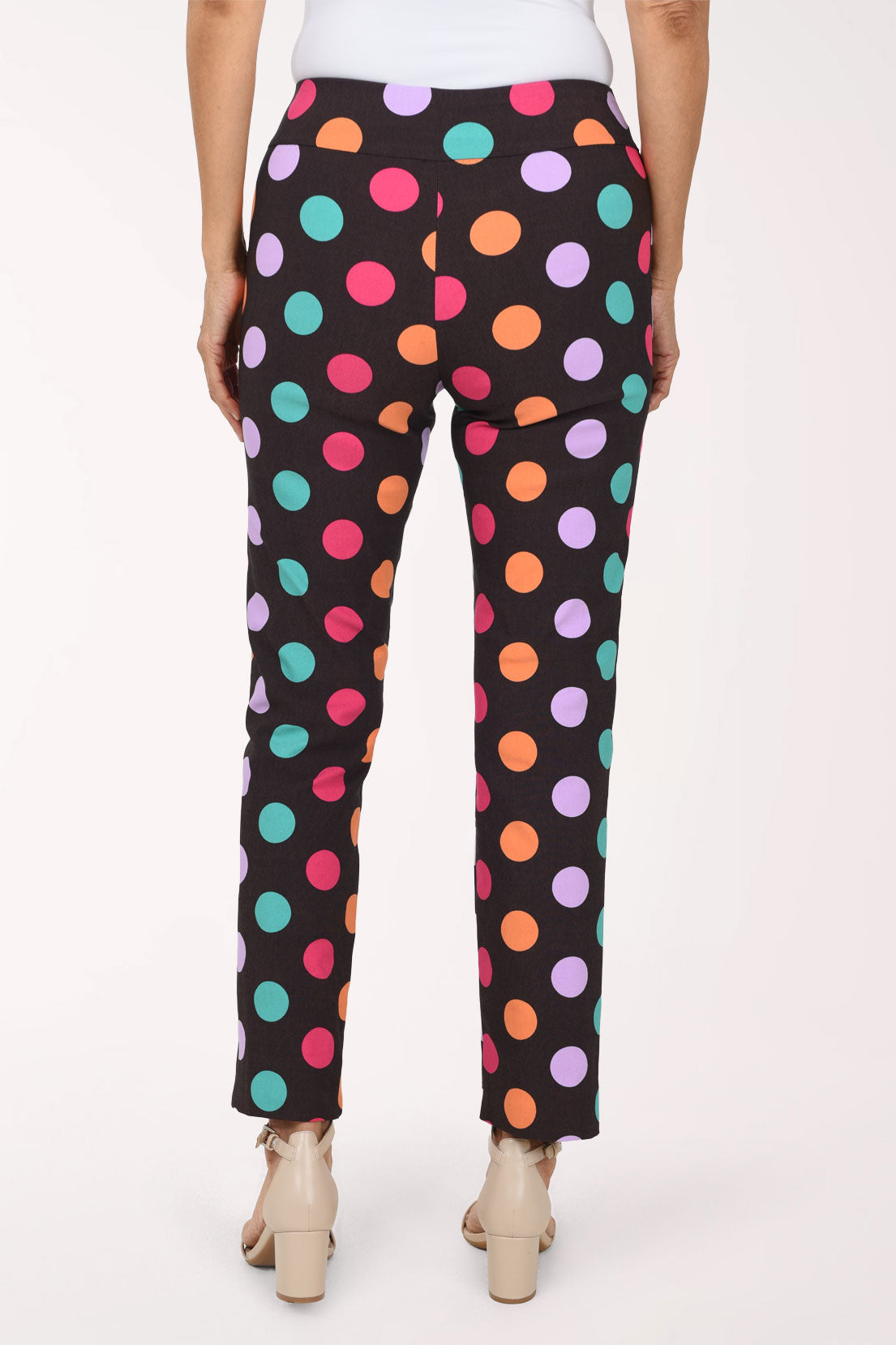 Women wearing black pull-on ankle pants with multicolored dots