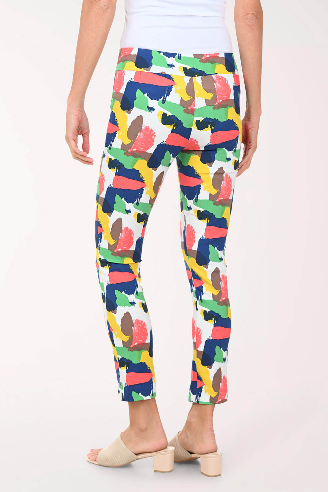 Person wearing colorful patterned pants on a white background