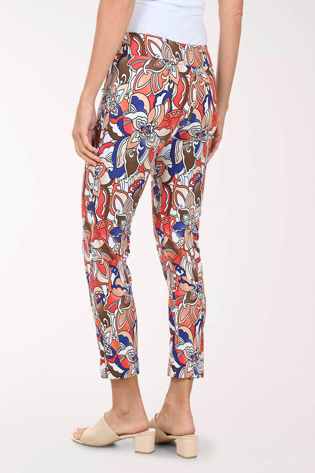 Colorful patterned pants worn by a person on a white background