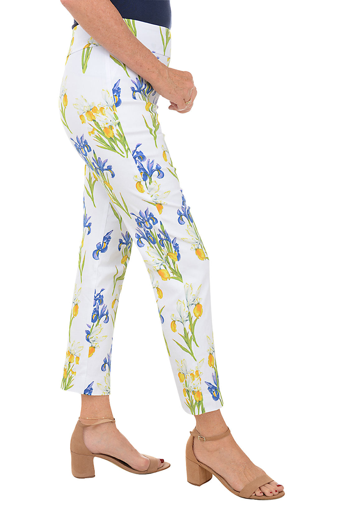 A side shot of a model wearing a pair of pull-on ankle pants with an elasticized waistband, featuring a white base with a blue and yellow floral pattern.