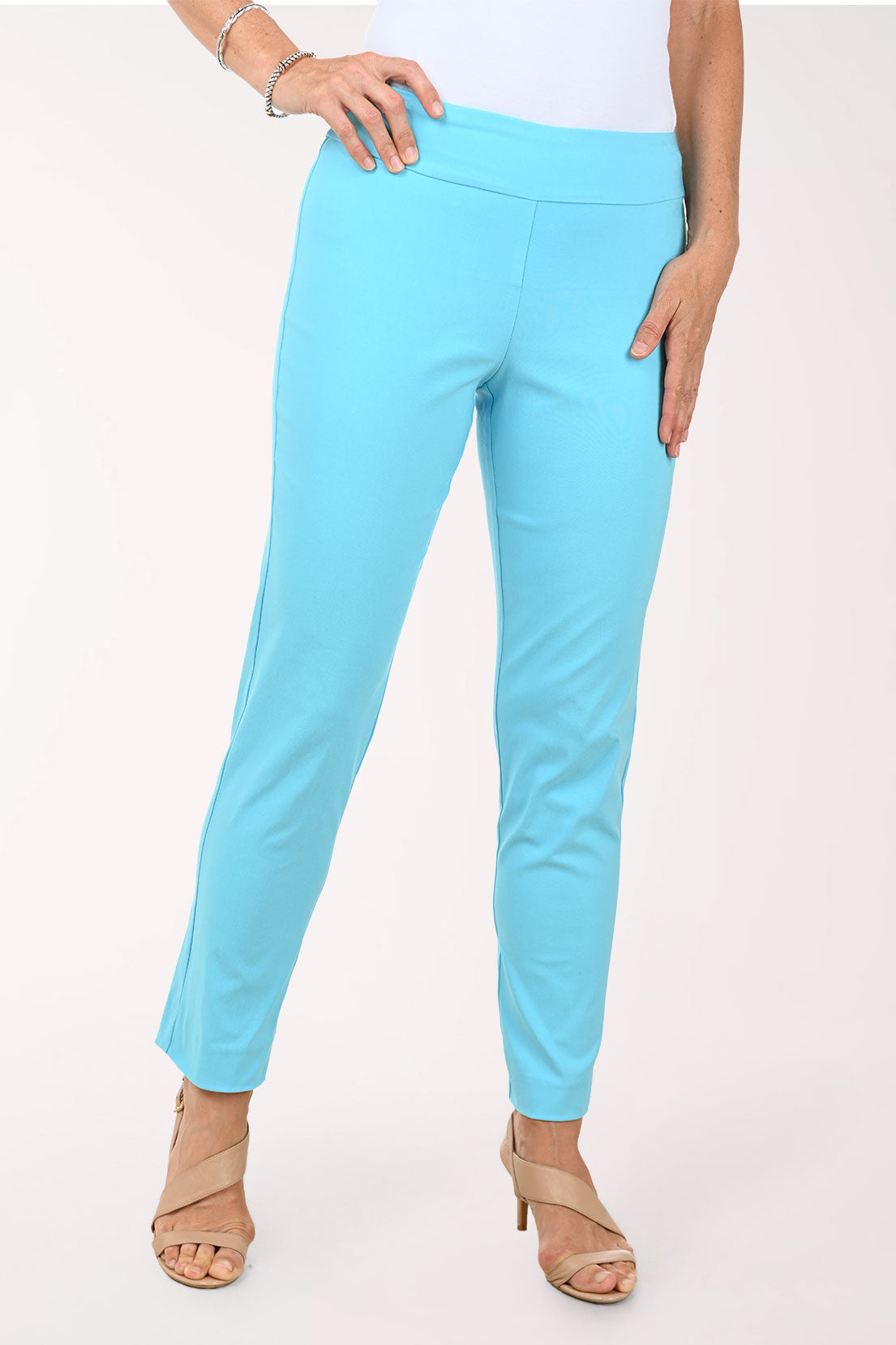 Person wearing turquoise pants on a white background