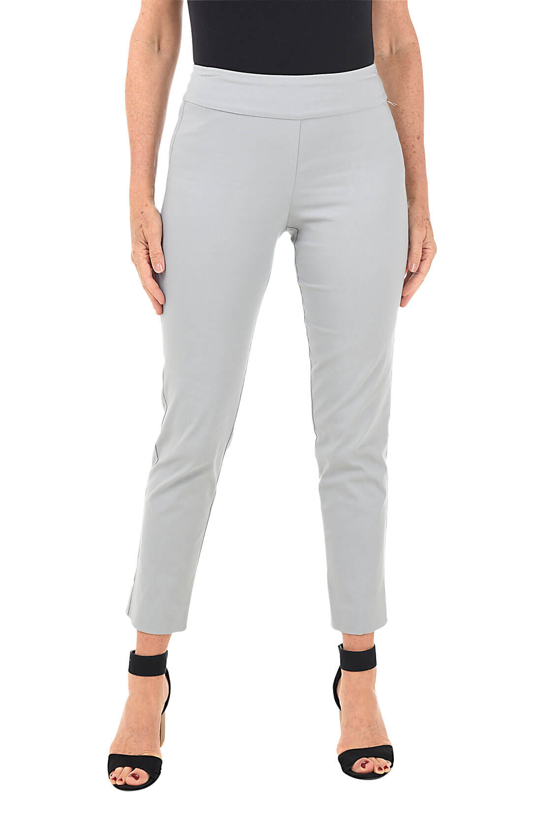 A front shot of a model wearing a cement pull-on ankle pant with a white top and beige wedges.
