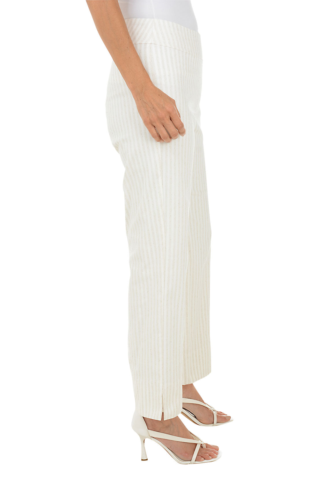 A side shot of a model wearing a pair of beige, oatmeal stripe flared ankle pants with an elastic waistband.