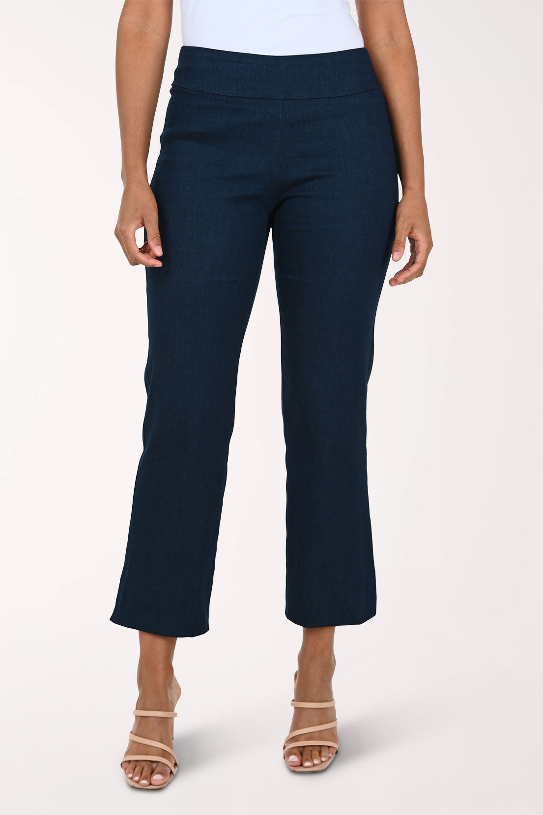 Denim blue pants worn by a person on a white background