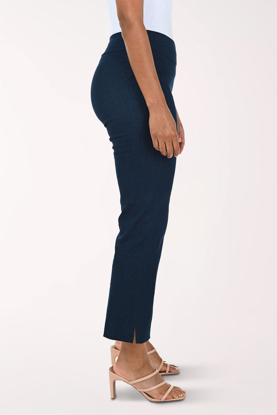 Denim blue pants worn by a person on a white background