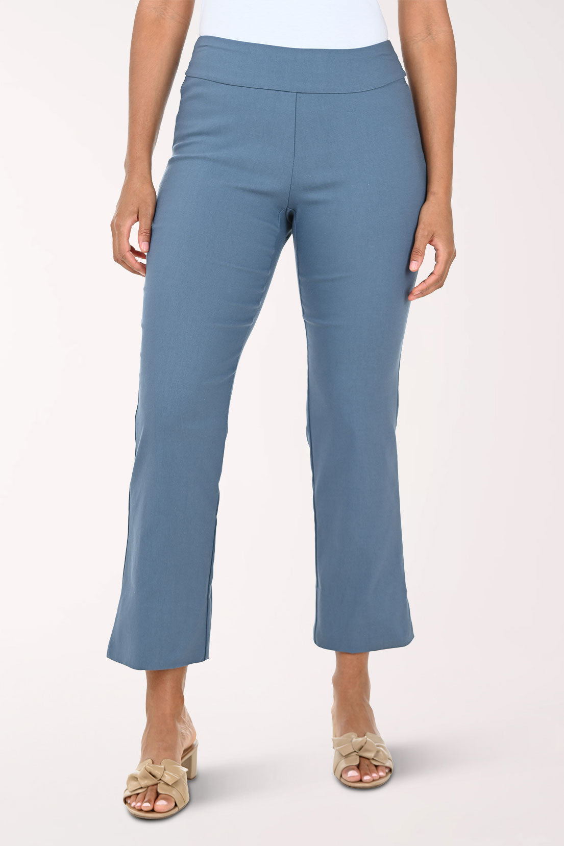 Blue pants worn by a person on a white background