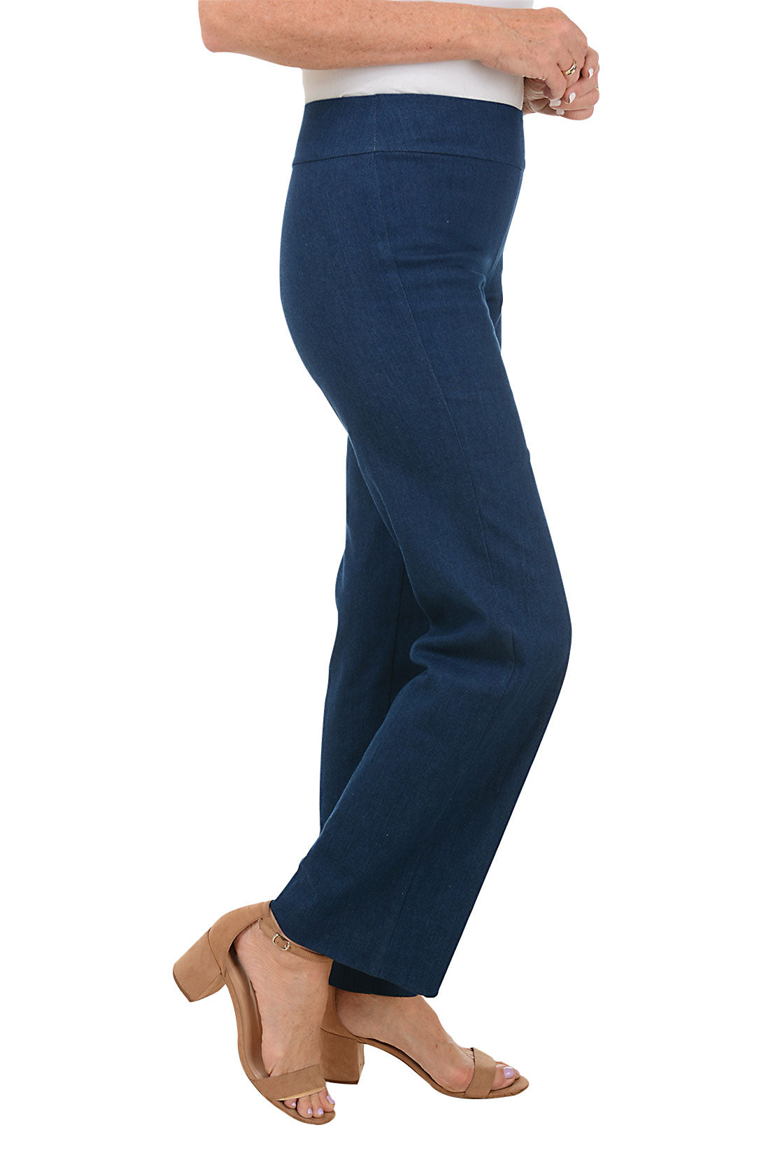 A side shot of a model wearing navy blue pull-on denim pants with an elasticized waistband and a flared leg.