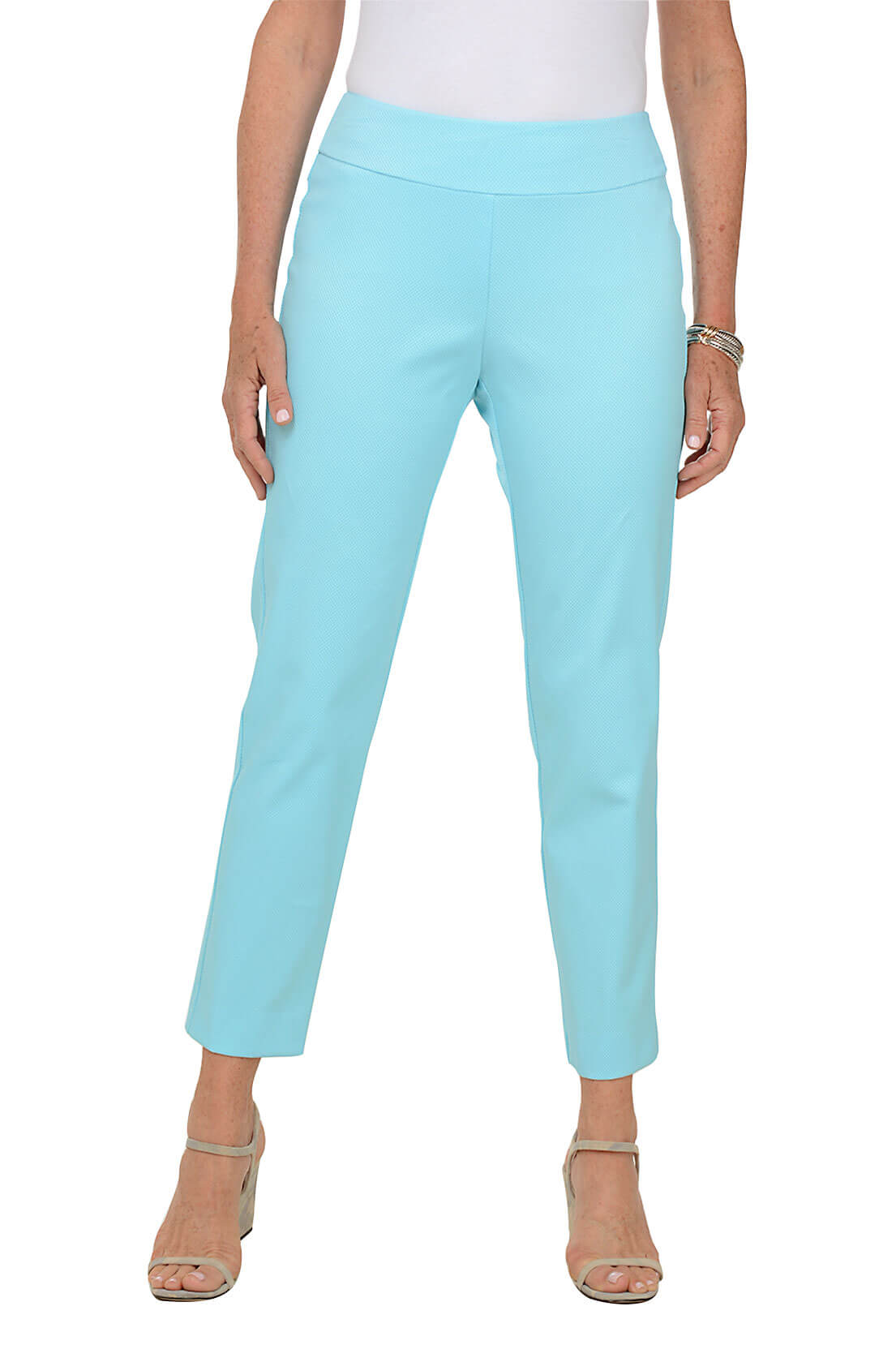 A front shot of a model wearing a aqua blue textured pull-on ankle pants with a mid-rise waist and slim fit.