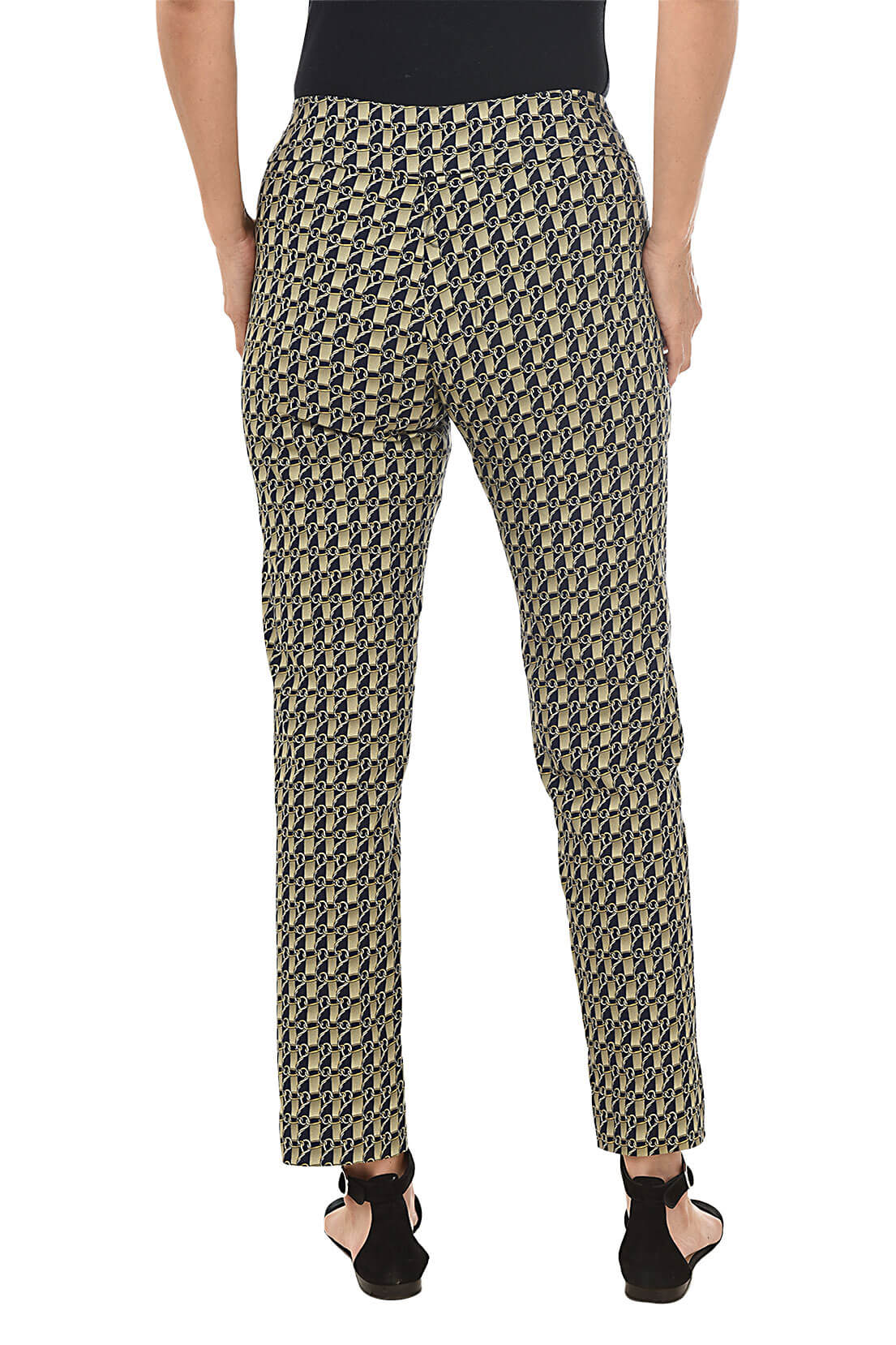 A back shot of a model wearing a pair of slim-fit golden link print pull-on ankle pants with an elasticized waistband, made from a blend of nylon, rayon, and spandex fabrics.