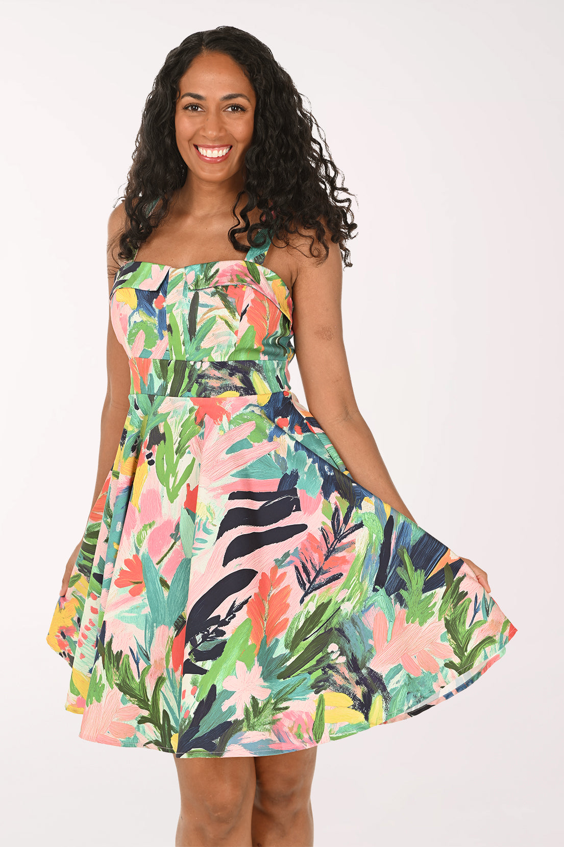Woman wearing a colorful floral dress on a white background