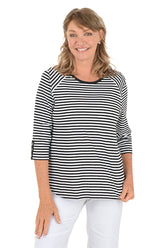 Woman wearing a black and white striped shirt on a white background.