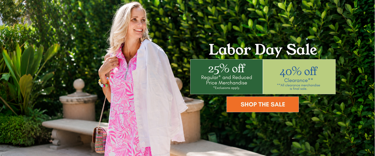 A woman stands outdoors in front of a green hedge wearing a pink and white tropical print dress and holding a white shawl. Large promotional text on the right reads 'Labor Day Sale' with discount details and an orange 'SHOP THE SALE' button.